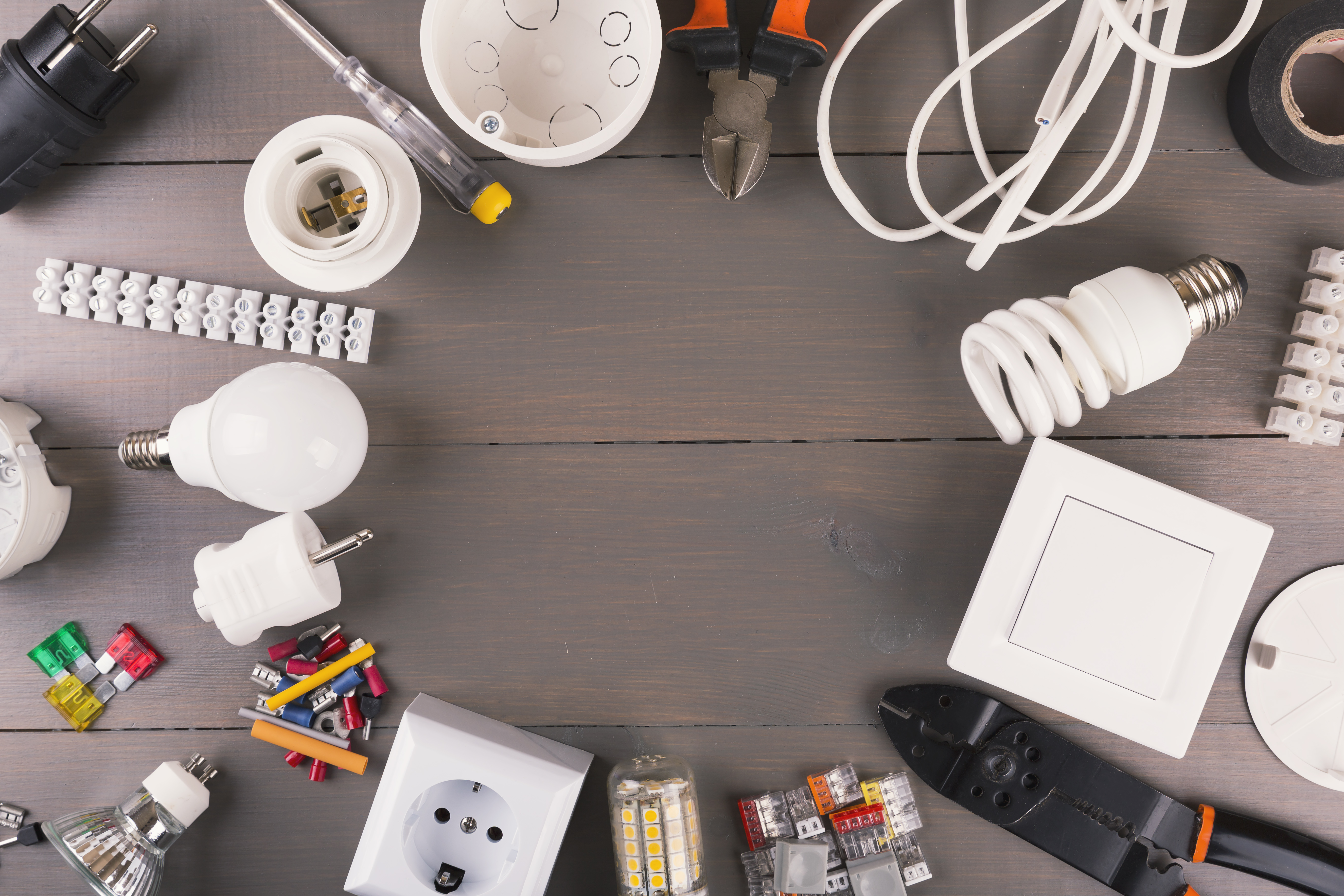 top view of electrical tools and equipment on gray wooden table